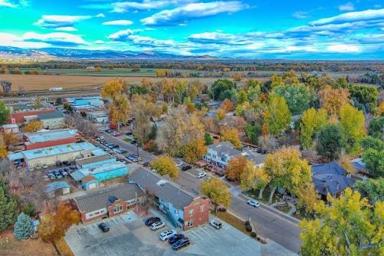 Aerial view of Niwot in autumn showing the commercial buildings, the street grid and the farmland and rail corridor beyond